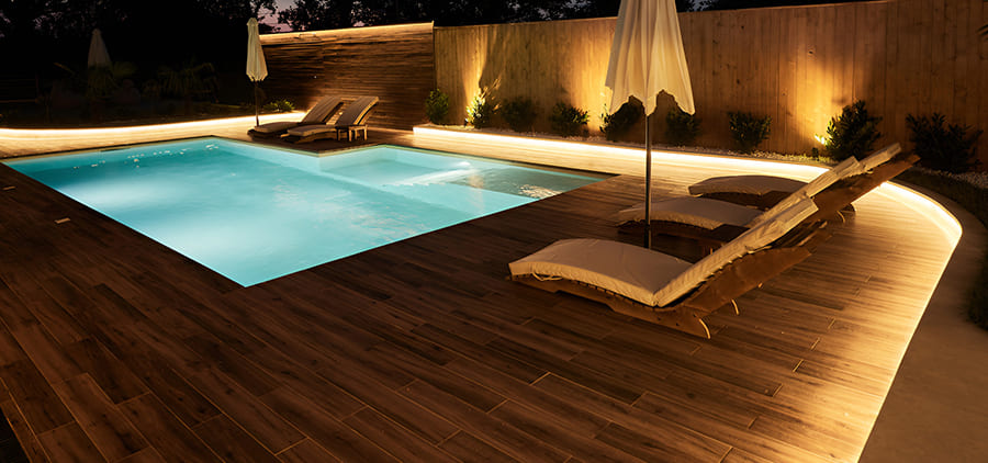 Pool deck with built-in LED lighting at night