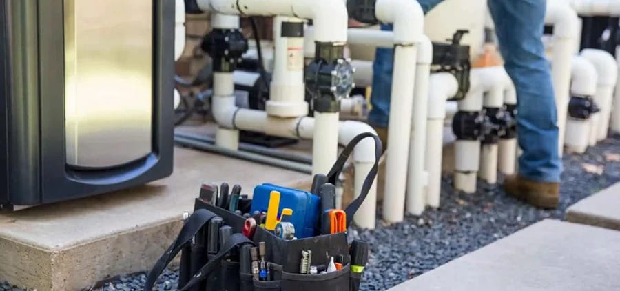 Technician installing new pool plumbing and equipment