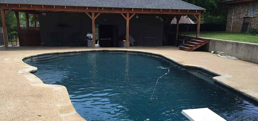 Remodeled pool with diving board and covered patio